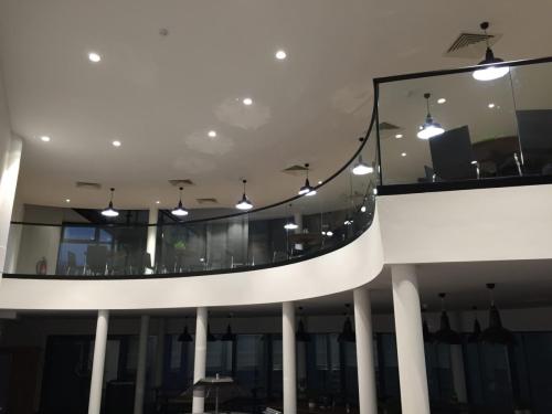 MBF1_curved_glass_frameless_balustrade_black_handrail